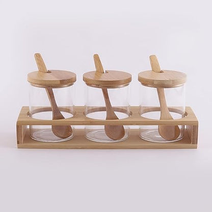 Cp Glass Triple Condiment Jar and Spoon with Wooden Stand (Spoon-13 * 3 * 0.4cm/Glass with lid-6.5 * 6.5 * 9.5cm/Stand- 24.5 * 8 * 4cm)